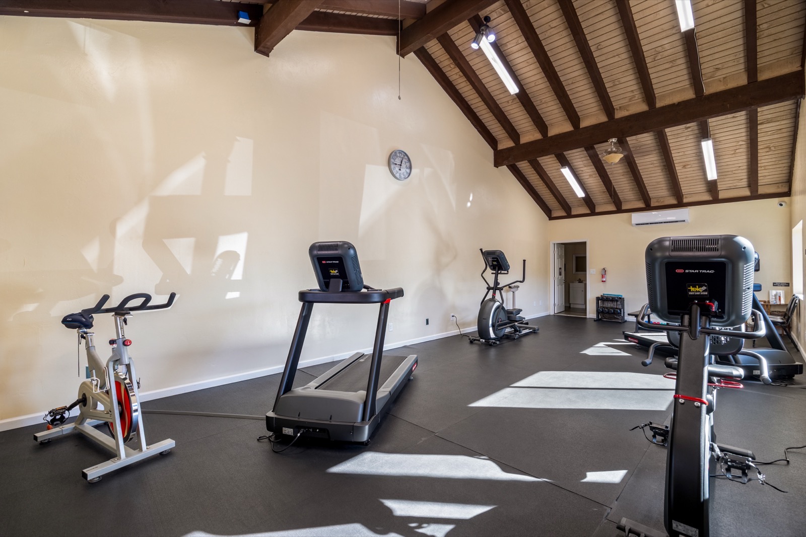 Fitness center with vaulted wood beam ceiling